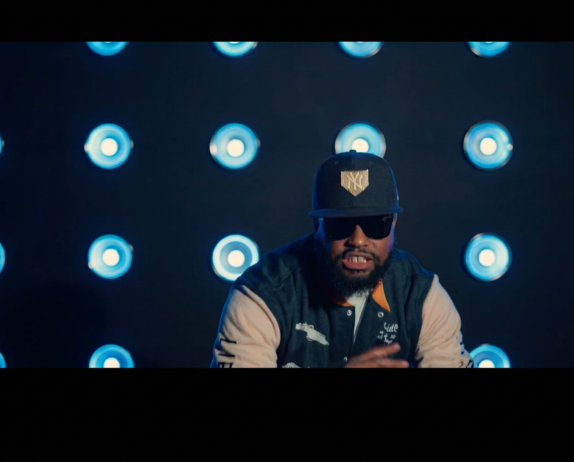 OCity HAZZ performing before a wall of blue stage lights